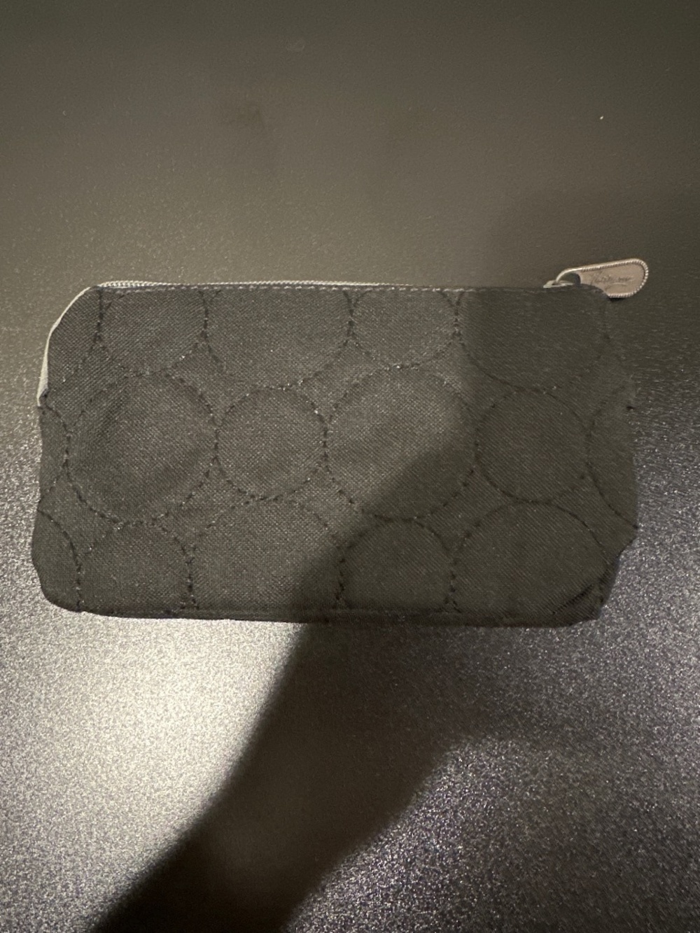 Black quilted wallet with grey zipper